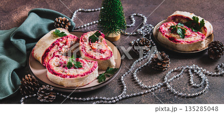 Traditional herring under a fur coat salad wrapped in pita bread on a plate web banner Traditional herring under a fur coat salad wrapped in pita bread on a plate web banner 135285048