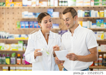 Man client with prescription should contact girl pharmacist for help, takes box remedy 135285175