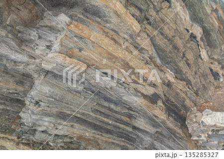 Close-up of layered rock formation showing natural geological patterns and textures 135285327