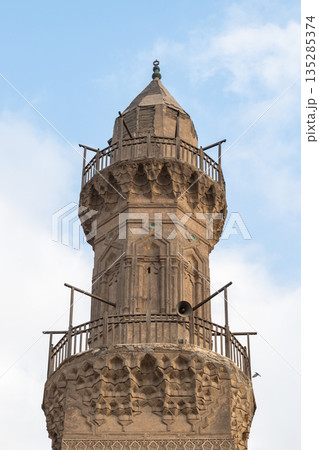 Historic Qalawun Complex in Cairo, featuring intricate architecture, tall minarets, and domes under a blue sky with clouds. A significant cultural landmark on Al-Muizz Street. Historic Qalawun Complex in Cairo, featuring intricate architecture, tall minarets, and domes under a blue sky with clouds. A significant cultural landmark on Al-Muizz Street. 135285374