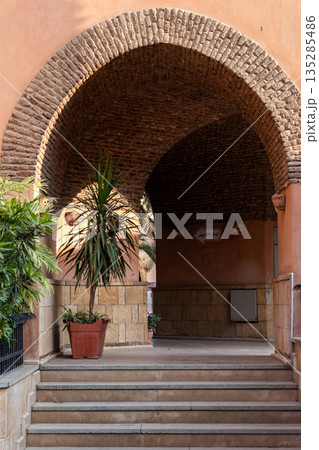 Narrow streets in Coptic Cairo lined with book stalls. People walk through the alley, exploring the vibrant local culture and history. Narrow streets in Coptic Cairo lined with book stalls. People walk through the alley, exploring the vibrant local culture and history. 135285486