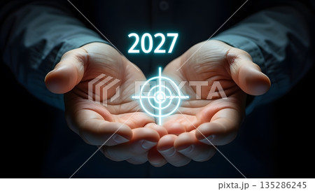 Future Vision: Hands Holding Target Symbol with Year 2027 Light 135286245