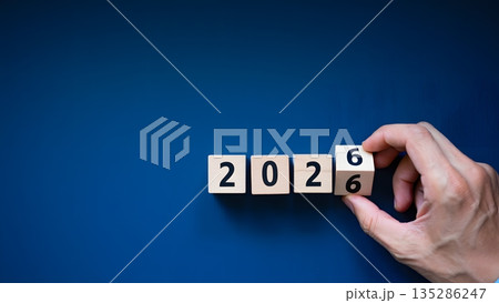 Hand Changing Number on Wooden Cubes for Year 2026 Celebration 135286247