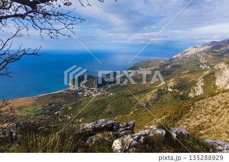 Breathtaking Mountain Overlook Over Coastal Village and Deep Blue Sea From Rugged Cliffs Breathtaking Mountain Overlook Over Coastal Village and Deep Blue Sea From Rugged Cliffs 135288929