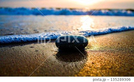 Single Smooth Grey Pebble on Wet Sand. Mental Mindfulness Concept. Generated Image Single Smooth Grey Pebble on Wet Sand. Mental Mindfulness Concept. Generated Image 135289306