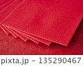 Multiple red envelopes layered together forming a clean Chinese New Year background. 135290467
