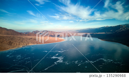 Aerial view of a frozen lake landscape with mountains. Nature Aerial view of a frozen lake landscape with mountains. Nature 135290988