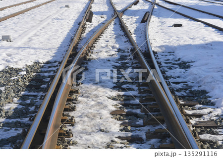 Snowy railway tracks and metal switches Snowy railway tracks and metal switches 135291116