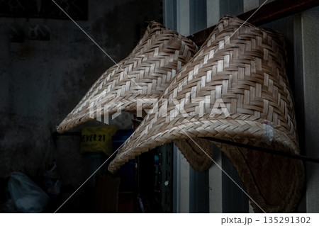 Close-up of Two bamboo basket steamer for steamed glutinous rice or sticky rice hanging on a stainless steel fence. Close-up of Two bamboo basket steamer for steamed glutinous rice or sticky rice hanging on a stainless steel fence. 135291302