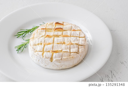 Baked camembert with toasted ciabatta garlic and rosemary garnish 135291348