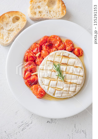 Baked camembert with rosemary garlic ciabatta and roasted cherry tomatoes plate gourmet white 135291353