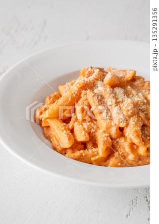 Penne pasta in creamy ricotta tomato sauce with grated parmesan cheese Penne pasta in creamy ricotta tomato sauce with grated parmesan cheese 135291356