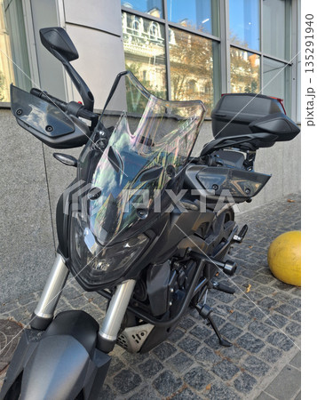 Motorcycle parked near an office building Motorcycle parked near an office building 135291940