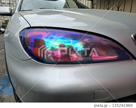 Neon-tinted headlights are an eye-catching feature of cars Neon-tinted headlights are an eye-catching feature of cars 135291960