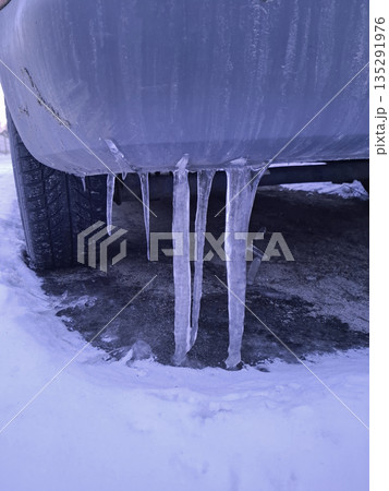The rear of the car was frozen to the ground by icicles The rear of the car was frozen to the ground by icicles 135291976