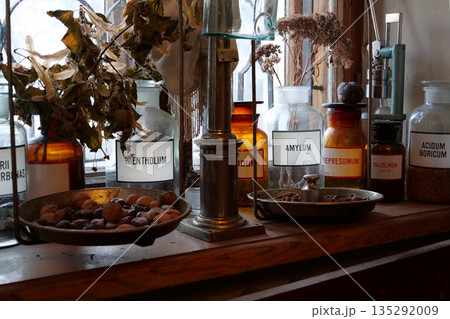 Old bottles with medications and chemicals substances in an old pharmacy 135292009