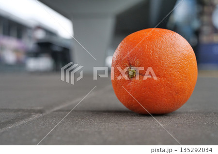Orange lies on the pavement 135292034