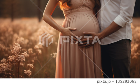 Man and woman holding pregnant bump expecting baby. Happy family hands on stomach closeup. 135292065