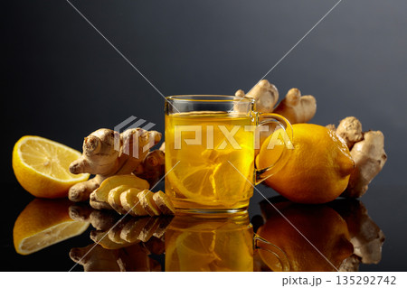 Ginger tea with lemon on a black background. Ginger tea with lemon on a black background. 135292742