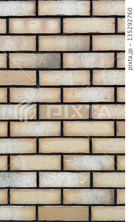 Modern sand-colored brick wall texture with striking black mortar joints for a stylish architectural background Modern sand-colored brick wall texture with striking black mortar joints for a stylish architectural background 135292760