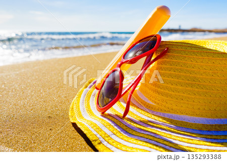 Sun protection acessories on beach 135293388