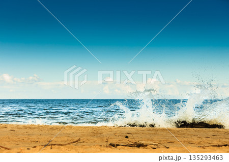 Sea waves on the shore of the sandy beach 135293463