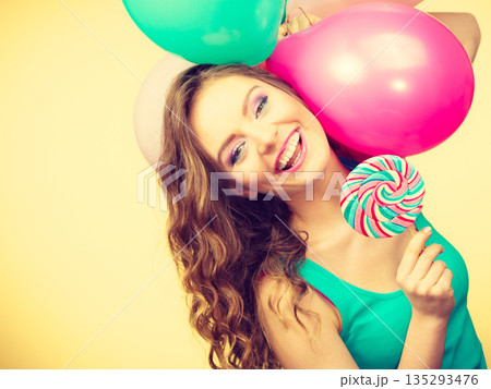 Woman with colorful balloons and lollipop Woman with colorful balloons and lollipop 135293476