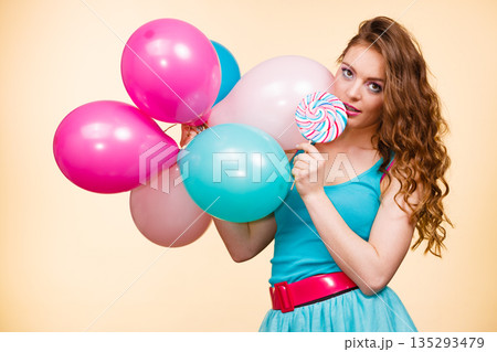 Woman with colorful balloons and lollipop Woman with colorful balloons and lollipop 135293479