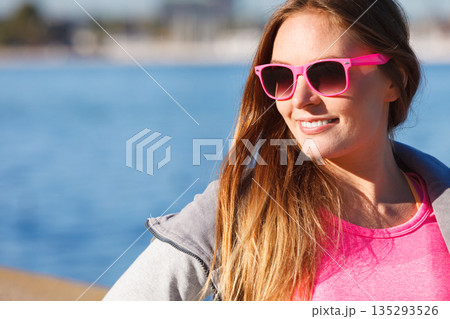 Woman resting relaxing after doing sports outdoors Woman resting relaxing after doing sports outdoors 135293526
