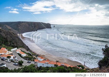 Praia da Arrifana beach framed by high cliffs on the wild west coast of Portugal - very popular beach with surfers Praia da Arrifana beach framed by high cliffs on the wild west coast of Portugal - very popular beach with surfers 135293572