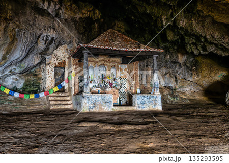 Dark interior of Lapa de Santa Margarida in Arrabida, Setubal, Portugal. Cave with small chapel of spontaneous worship 135293595