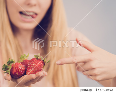 Girl showing fresh strawberries Girl showing fresh strawberries 135293658