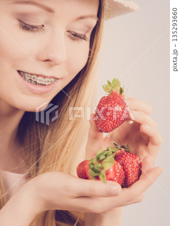 Young woman with fresh strawberries Young woman with fresh strawberries 135293660