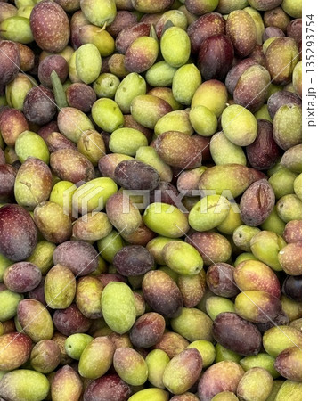 Olives in varied shades of green and purple create natural vibrant background 135293754
