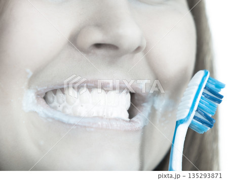 Woman brushing cleaning teeth. 135293871