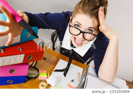 Depressed businesswoman sitting at desk Depressed businesswoman sitting at desk 135293894