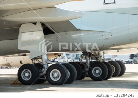 Close up of the main landing gear wheels on a wide-body aircraft 135294245