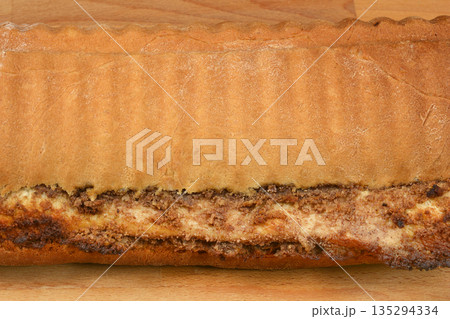 Baked walnut roll crust and filling close up 135294334