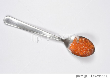 Red trout caviar on a silver spoon 135294344