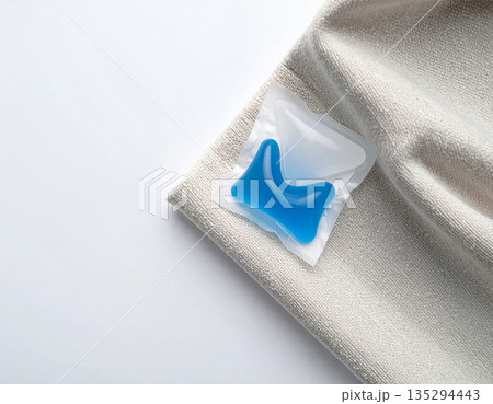 Washing pods. Soluble laundry detergent capsule on a neutral linen cloth with empty space for text. 135294443