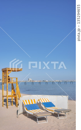 Beach with a lifeguard tower and sun loungers, Hurghada, Egypt. 135294655