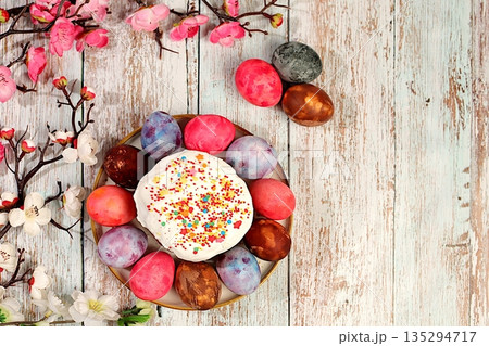 Traditional kulich and marbled Easter eggs painted with onion peel, hibiscus tea and pink matcha with sakura branches, Easter celebration concept, Easter dish ideas for home cooking Traditional kulich and marbled Easter eggs painted with onion peel, hibiscus tea and pink matcha with sakura branches, Easter celebration concept, Easter dish ideas for home cooking 135294717