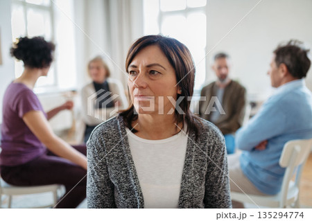 Portrait of woman during group therapy. 135294774