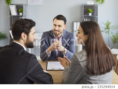 Couple meeting with financial adviser, insurance agent for advice on legal document and agreement. Couple meeting with financial adviser, insurance agent for advice on legal document and agreement. 135294914