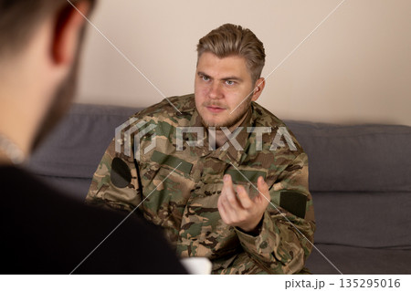 Soldier talking to therapist on the sofa Soldier talking to therapist on the sofa 135295016