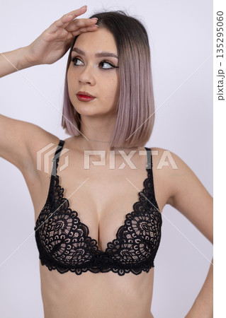 Woman in black lace lingerie with hands near face 135295060