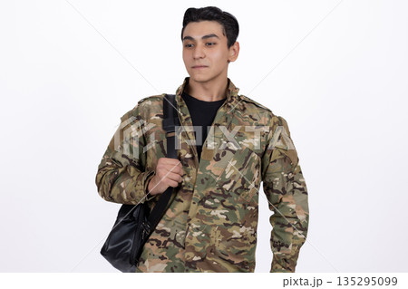 Soldier in camouflage uniform with a black backpack Soldier in camouflage uniform with a black backpack 135295099