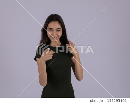 Confident woman pointing at herself with both hands 135295101