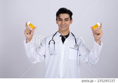 Doctor showing two jars of medical pills 135295137