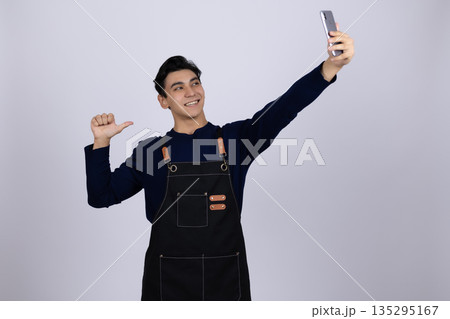 Happy young chef taking selfie with smartphone Happy young chef taking selfie with smartphone 135295167